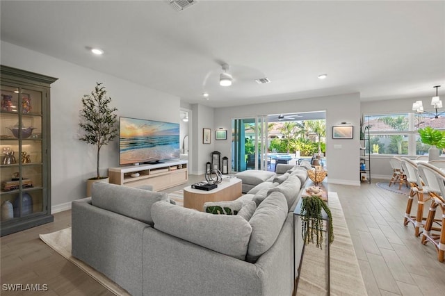 10581 Woodchuck Ln, Bonita Springs, FL 34135 - living area featuring light wood-style floors, plenty of natural light, a chandelier, ceiling fan, and recessed lighting