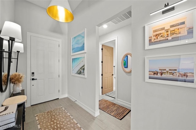 10581 Woodchuck Ln, Bonita Springs, FL 34135 - entryway featuring wood finished floors and baseboards