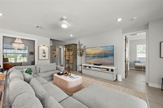 10581 Woodchuck Ln, Bonita Springs, FL 34135 - living area featuring light wood-type flooring, recessed lighting, and a chandelier