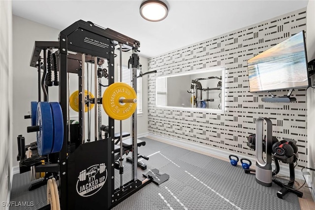 10581 Woodchuck Ln, Bonita Springs, FL 34135 - exercise room with wallpapered walls and an accent wall