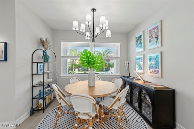 10581 Woodchuck Ln, Bonita Springs, FL 34135 - dining area with a chandelier and light wood-type flooring