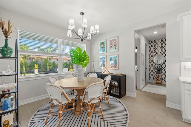 10581 Woodchuck Ln, Bonita Springs, FL 34135 - dining space with a chandelier and light wood finished floors