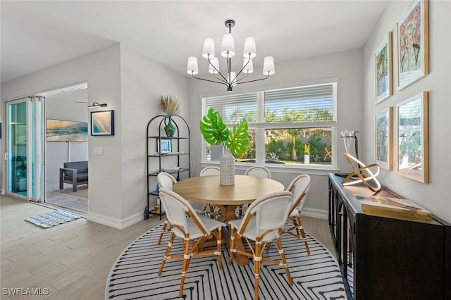 10581 Woodchuck Ln, Bonita Springs, FL 34135 - dining area with light wood-style floors and a chandelier