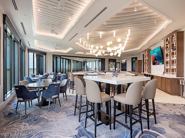 5051 Pelican Colony Blvd Unit 401, Bonita Springs, FL 34134 - dining space featuring a tray ceiling, a chandelier, wooden ceiling, and light colored carpet