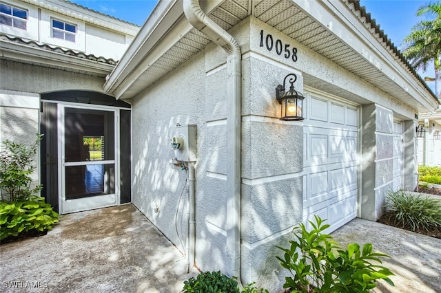 10058 Pacific Pines Ave, Fort Myers, FL 33966 - view of side of home featuring stucco siding and a tile roof