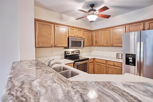 10058 Pacific Pines Ave, Fort Myers, FL 33966 - kitchen with appliances with stainless steel finishes, ceiling fan, light countertops, and brown cabinets