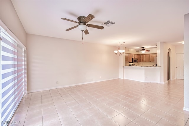 10058 Pacific Pines Ave, Fort Myers, FL 33966 - unfurnished living room with ceiling fan, arched walkways, light tile patterned floors, and a chandelier