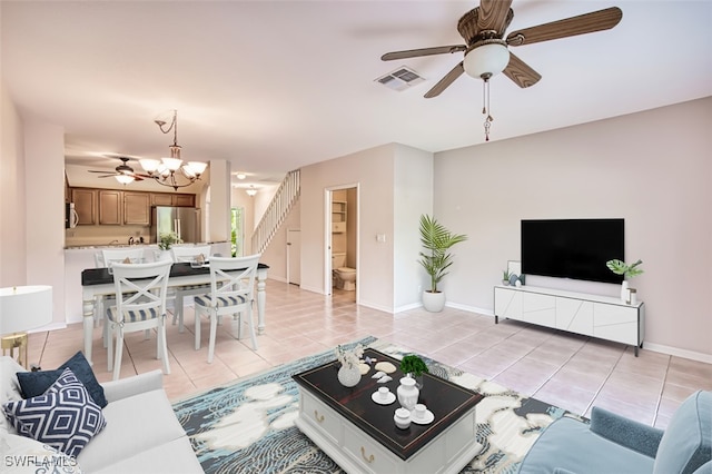 10058 Pacific Pines Ave, Fort Myers, FL 33966 - living room with ceiling fan, light tile patterned flooring, stairs, and a chandelier