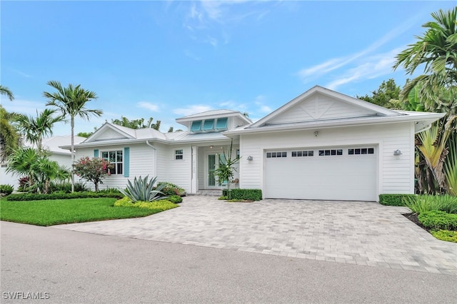 2120 Curtis St, Naples, FL 34112 - view of front facade featuring decorative driveway, an attached garage, and a front yard