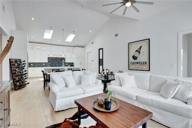 2120 Curtis St, Naples, FL 34112 - living area with a skylight, a ceiling fan, light wood-style flooring, high vaulted ceiling, and recessed lighting