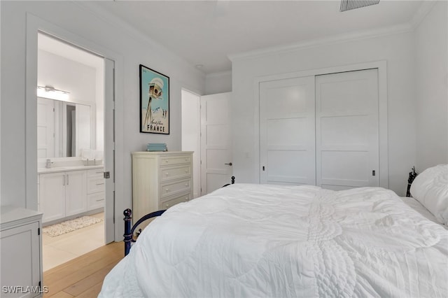 2120 Curtis St, Naples, FL 34112 - bedroom featuring crown molding, light wood-style floors, a closet, and ensuite bath