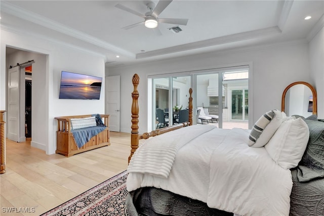 2120 Curtis St, Naples, FL 34112 - bedroom with a tray ceiling, light wood finished floors, a barn door, access to exterior, and crown molding