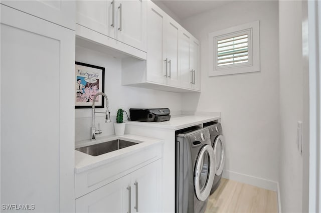2120 Curtis St, Naples, FL 34112 - washroom featuring independent washer and dryer, cabinet space, and light wood finished floors