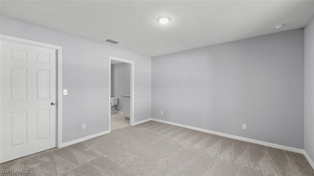 2816 27th St SW, Lehigh Acres, FL 33976 - unfurnished bedroom featuring carpet flooring and connected bathroom