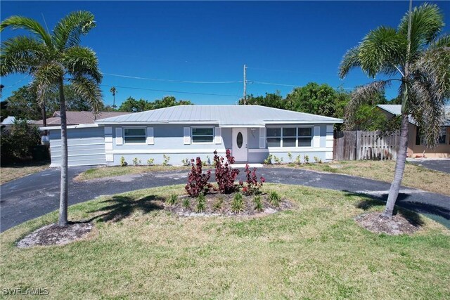 1141 S Alhambra Cir, Naples, FL 34103 - ranch-style house with driveway and stucco siding
