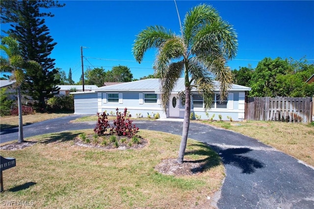 1141 S Alhambra Cir, Naples, FL 34103 - single story home featuring asphalt driveway and stucco siding