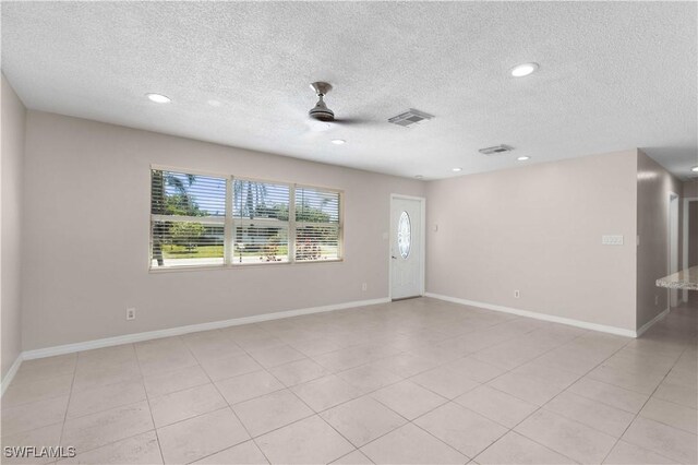 1141 S Alhambra Cir, Naples, FL 34103 - empty room with a textured ceiling and recessed lighting