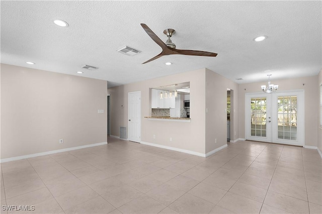 1141 S Alhambra Cir, Naples, FL 34103 - unfurnished living room featuring a textured ceiling, ceiling fan, a chandelier, recessed lighting, and french doors