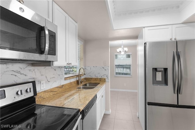 1141 S Alhambra Cir, Naples, FL 34103 - kitchen featuring appliances with stainless steel finishes, a chandelier, white cabinets, light stone countertops, and crown molding