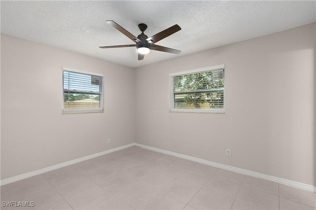 1141 S Alhambra Cir, Naples, FL 34103 - spare room with healthy amount of natural light, ceiling fan, and a textured ceiling