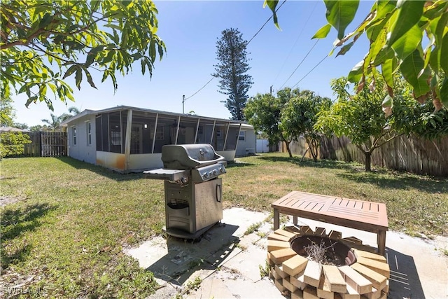 1141 S Alhambra Cir, Naples, FL 34103 - fenced backyard with a sunroom and an outdoor fire pit