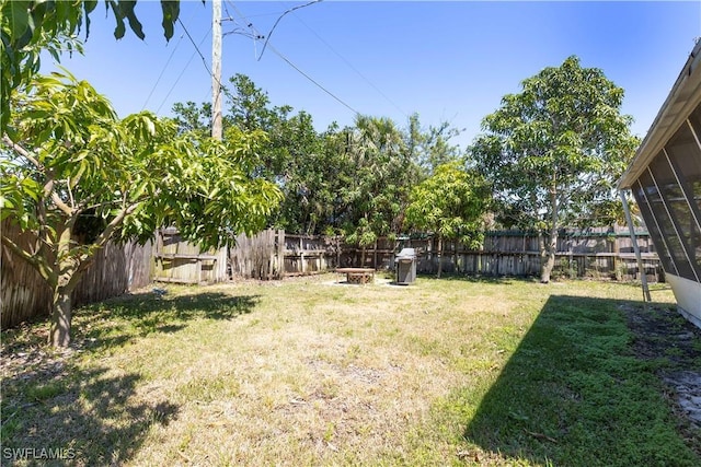 1141 S Alhambra Cir, Naples, FL 34103 - fenced backyard with an outdoor fire pit and a sunroom