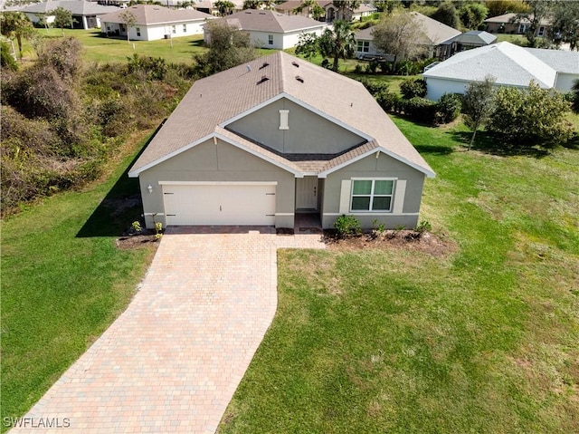 616 Posadas Cir, Punta Gorda, FL 33983 - single story home with an attached garage, decorative driveway, a residential view, and a front lawn