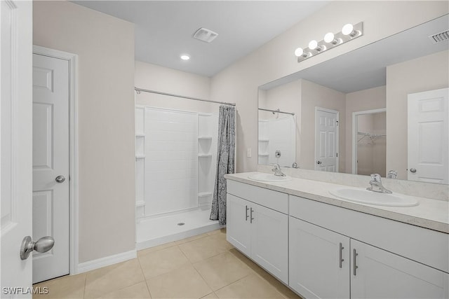 616 Posadas Cir, Punta Gorda, FL 33983 - bathroom featuring tile patterned floors, double vanity, a shower with shower curtain, and a walk in closet