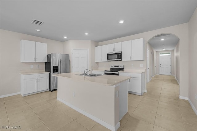 616 Posadas Cir, Punta Gorda, FL 33983 - kitchen with appliances with stainless steel finishes, arched walkways, light countertops, white cabinets, and light tile patterned flooring