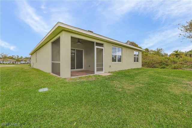 616 Posadas Cir, Punta Gorda, FL 33983 - back of house featuring stucco siding, a yard, and a ceiling fan