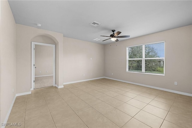616 Posadas Cir, Punta Gorda, FL 33983 - empty room featuring a ceiling fan, light tile patterned flooring, and a smoke detector