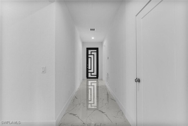 7014 Alfa Cir, Labelle, FL 33935 - corridor featuring light marble finish floors and recessed lighting