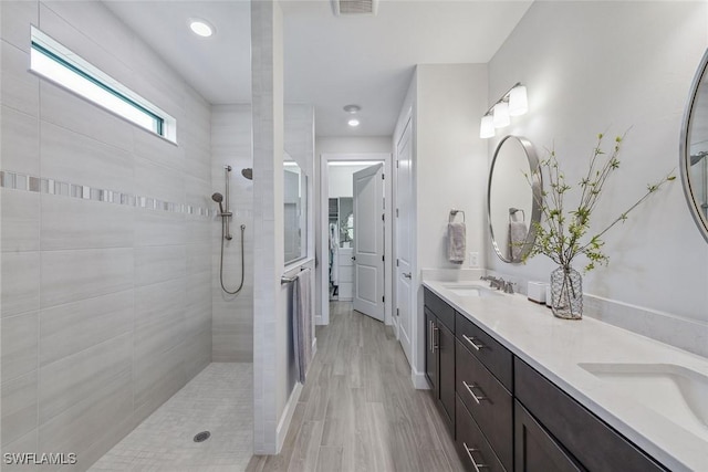 2703 Aviamar Cir, Naples, FL 34114 - full bathroom featuring double vanity, walk in shower, wood finished floors, and recessed lighting