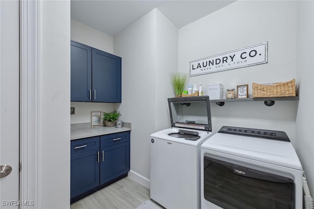 2703 Aviamar Cir, Naples, FL 34114 - laundry room featuring washer and dryer, cabinet space, and light wood finished floors