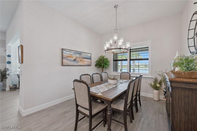 2703 Aviamar Cir, Naples, FL 34114 - dining space featuring a chandelier and light wood-style flooring