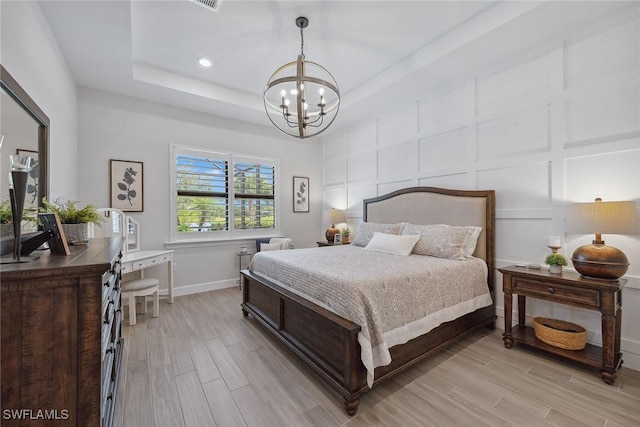2703 Aviamar Cir, Naples, FL 34114 - bedroom with a chandelier, light wood-style floors, a raised ceiling, an office area, and recessed lighting