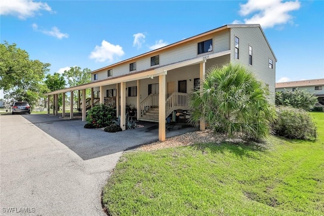 13532 Siesta Pines Ct Unit 5, Fort Myers, FL 33908 - view of front of home featuring a front yard, covered porch, and stairway