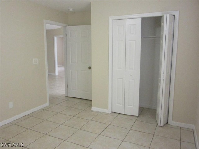 1568/1570 Gilbert Ave S, Lehigh Acres, FL 33973 - unfurnished bedroom with light tile patterned floors and a closet