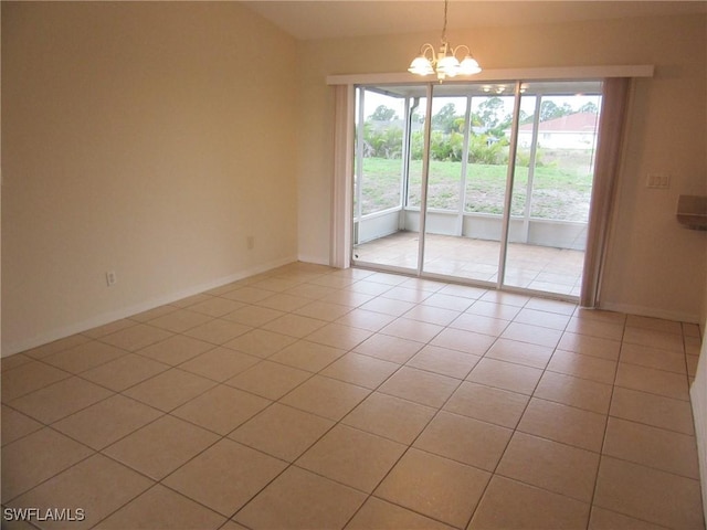 1568/1570 Gilbert Ave S, Lehigh Acres, FL 33973 - spare room featuring a chandelier and light tile patterned flooring