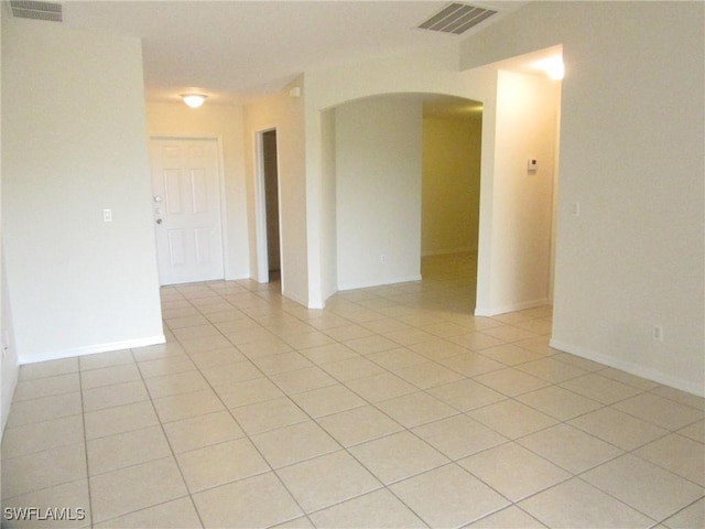 1568/1570 Gilbert Ave S, Lehigh Acres, FL 33973 - unfurnished room with arched walkways and light tile patterned floors