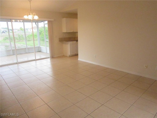 1568/1570 Gilbert Ave S, Lehigh Acres, FL 33973 - unfurnished room with a chandelier and light tile patterned floors