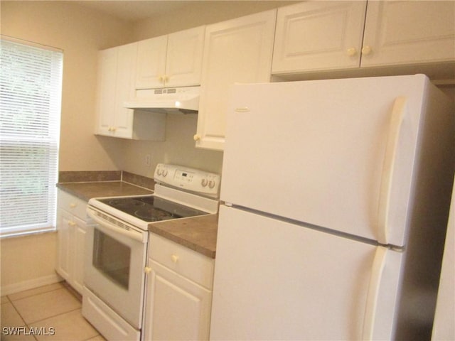 1568/1570 Gilbert Ave S, Lehigh Acres, FL 33973 - kitchen featuring white appliances, under cabinet range hood, white cabinets, light tile patterned floors, and dark countertops