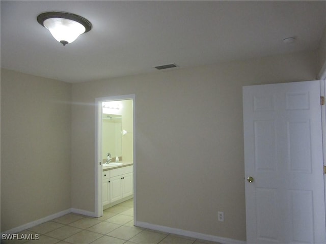 1568/1570 Gilbert Ave S, Lehigh Acres, FL 33973 - unfurnished room featuring baseboards and light tile patterned flooring