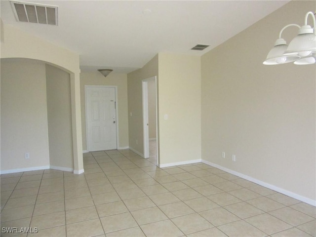 1568/1570 Gilbert Ave S, Lehigh Acres, FL 33973 - unfurnished room featuring arched walkways and light tile patterned floors