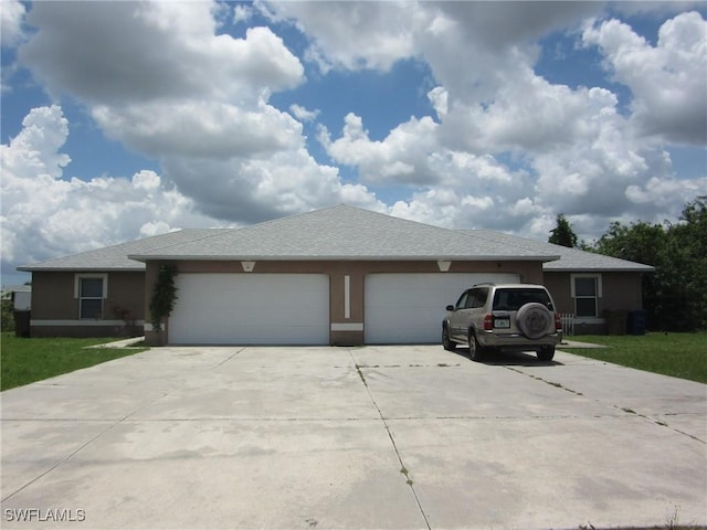 1568/1570 Gilbert Ave S, Lehigh Acres, FL 33973 - view of front facade featuring concrete driveway, an attached garage, and stucco siding