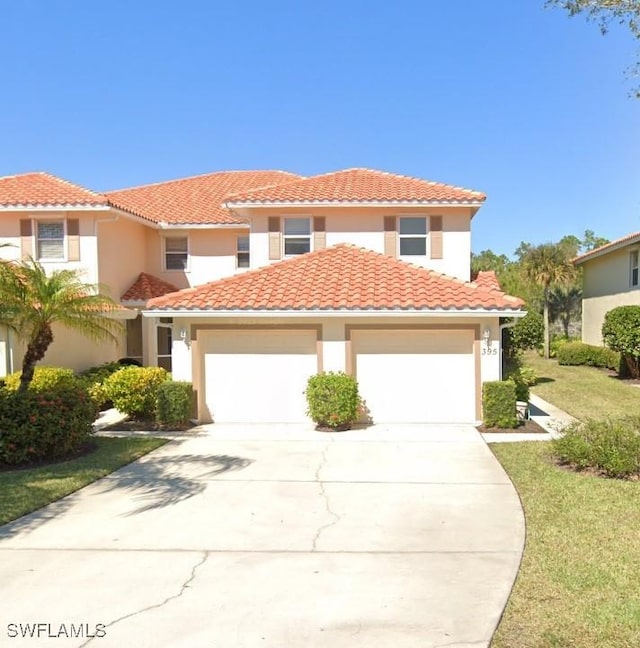 395 Robin Hood Cir Unit 201, Naples, FL 34104 - mediterranean / spanish home featuring driveway, a garage, stucco siding, a tiled roof, and a front yard