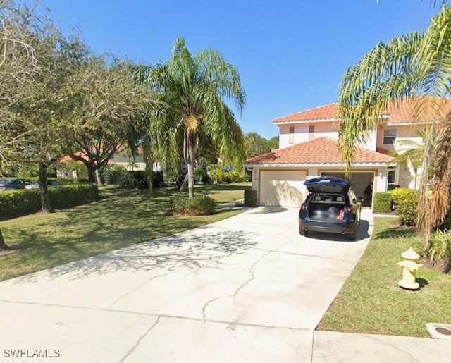 395 Robin Hood Cir Unit 201, Naples, FL 34104 - view of front of home featuring concrete driveway, stucco siding, a front lawn, a garage, and a tiled roof