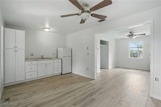 4011 Coconut Cir S, Naples, FL 34104 - kitchen with freestanding refrigerator, a ceiling fan, light wood-style flooring, and white cabinetry