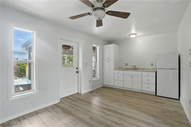 4011 Coconut Cir S, Naples, FL 34104 - kitchen featuring freestanding refrigerator, light wood-style floors, white cabinets, and ceiling fan