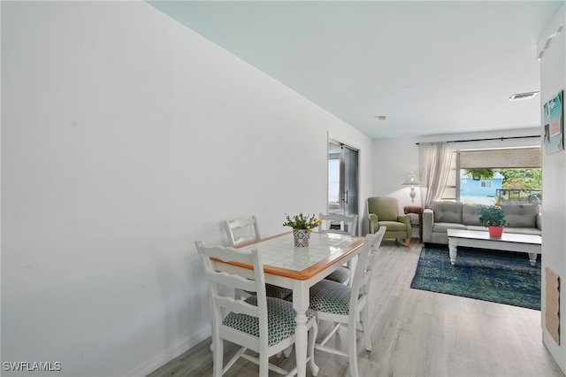 4011 Coconut Cir S, Naples, FL 34104 - dining space featuring light wood-type flooring and baseboards